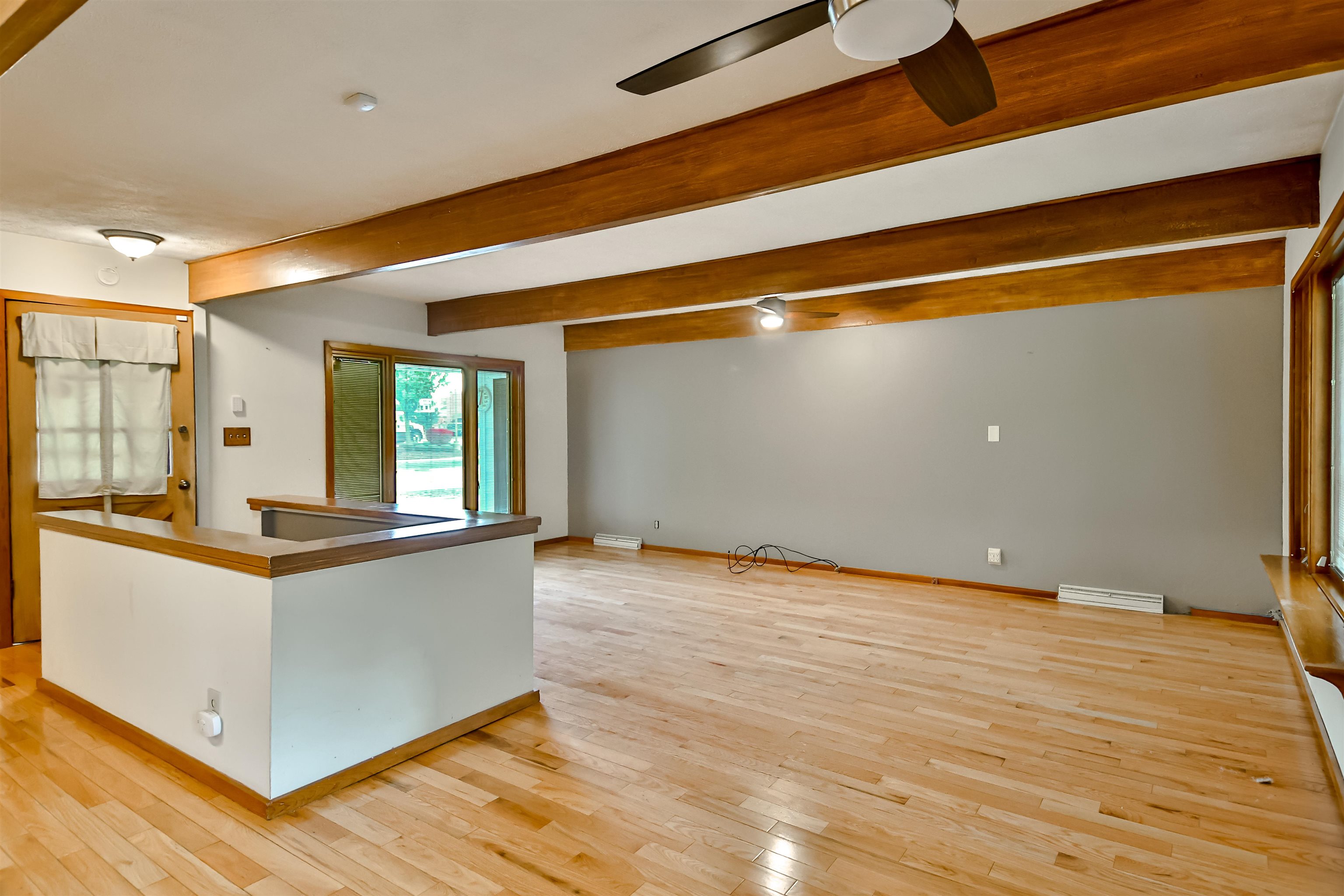 4520 Guilford Road Rockford, IL 61107 - Photo 15 of 28 a view of a kitchen with kitchen island a sink wooden floor and living room