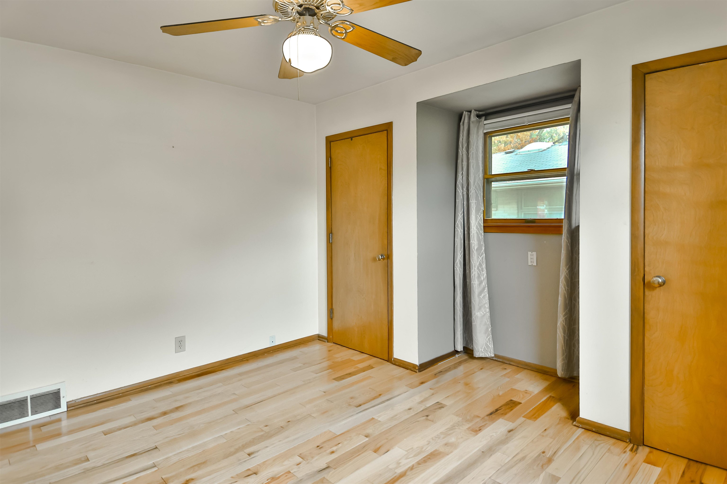 4520 Guilford Road Rockford, IL 61107 - Photo 19 of 28 a view of an empty room with wooden floor and a window