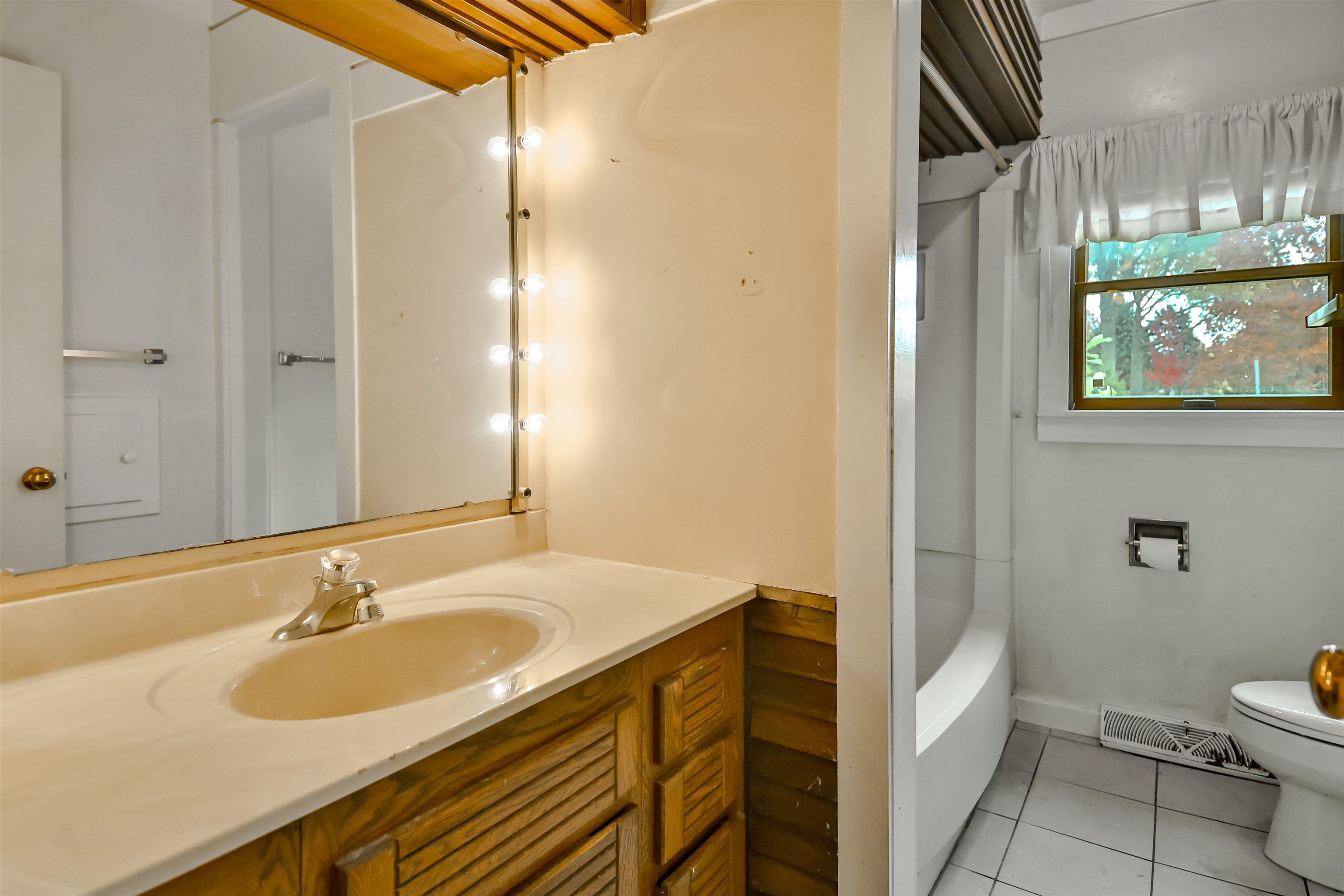 4520 Guilford Road Rockford, IL 61107 - Photo 21 of 28 a bathroom with a sink and a mirror