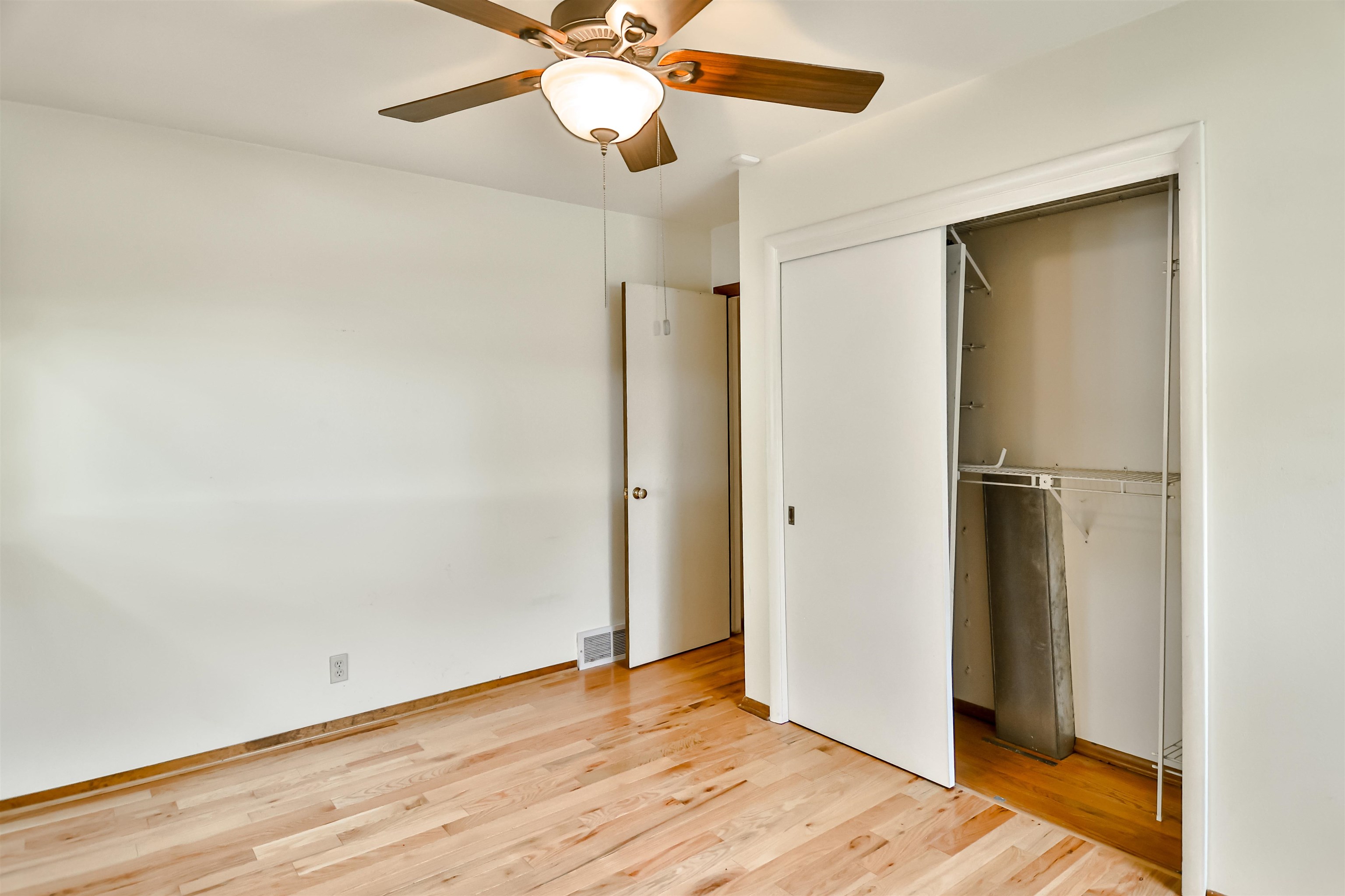 4520 Guilford Road Rockford, IL 61107 - Photo 24 of 28 an empty room with wooden floor closet and windows