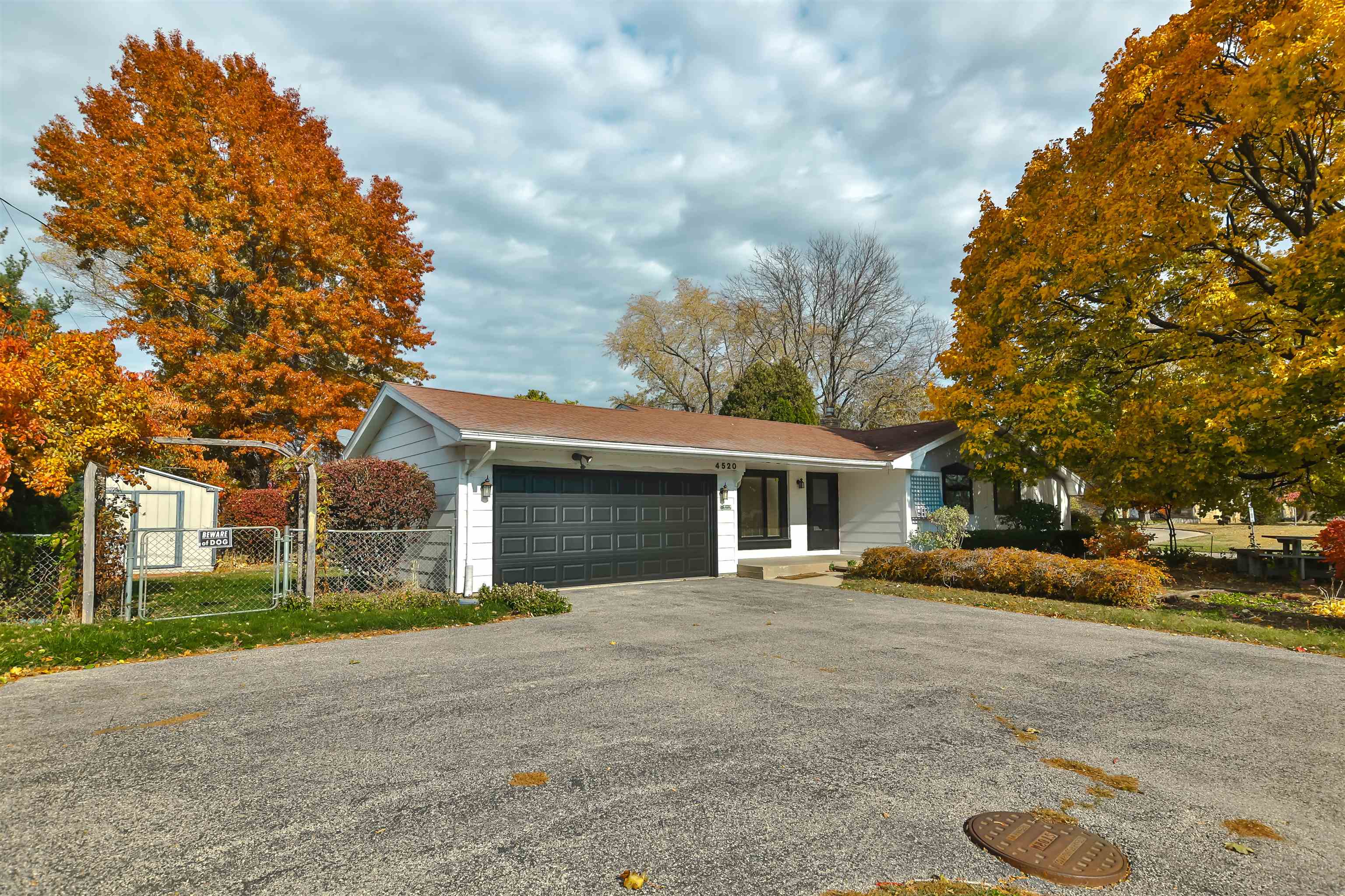 4520 Guilford Road Rockford, IL 61107 - Photo 4 of 28 a front view of a house with a yard and garage