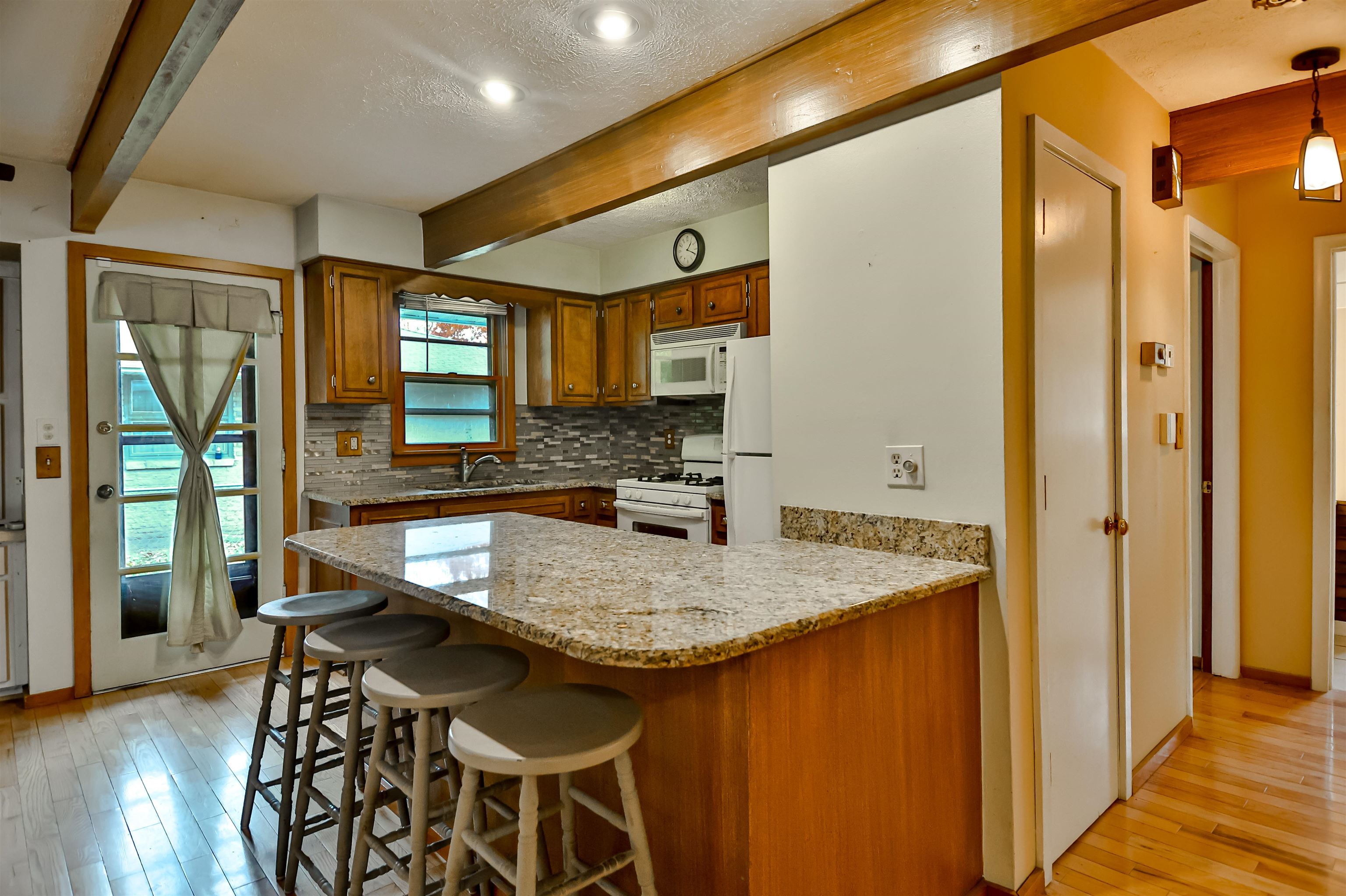 4520 Guilford Road Rockford, IL 61107 - Photo 10 of 28 a kitchen with stainless steel appliances granite countertop wooden cabinets a sink and a refrigerator