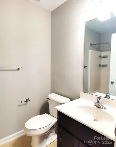 a bathroom with a sink a toilet and mirror
