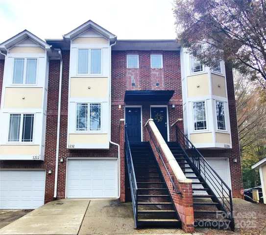a front view of a house with stairs