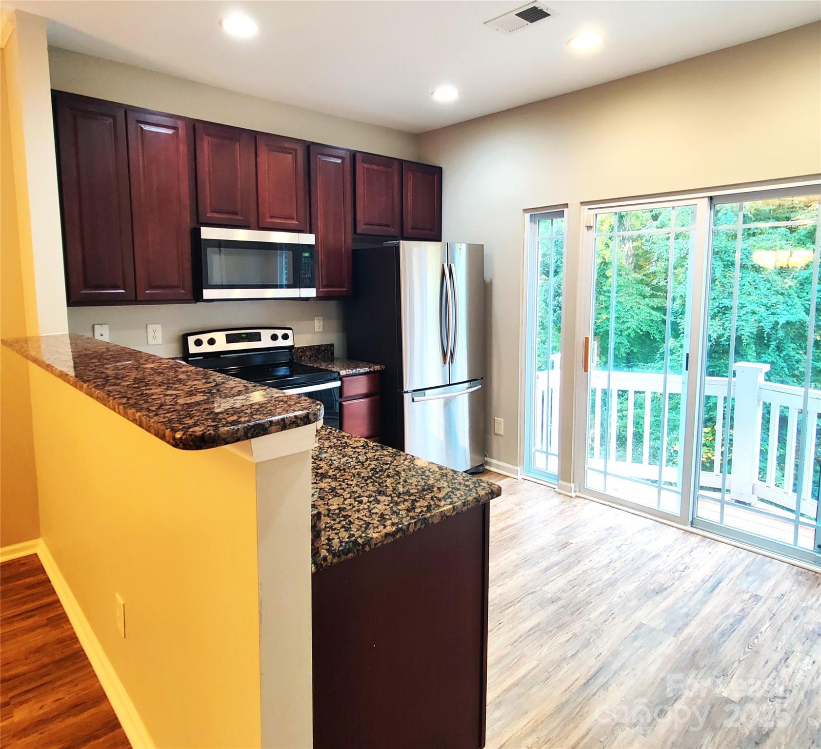 1132 Kurt Court Charlotte, NC 28209 - Photo 6 of 24 a kitchen with granite countertop a refrigerator and a sink