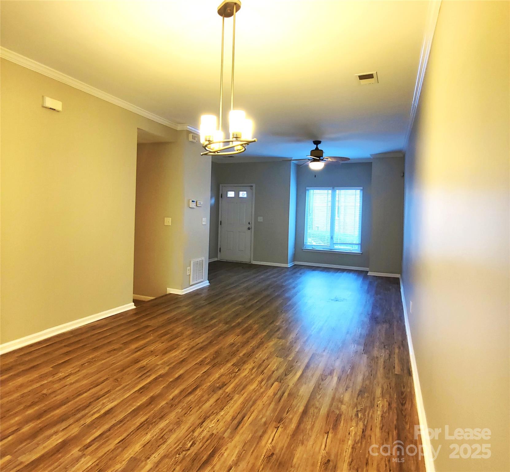 1132 Kurt Court Charlotte, NC 28209 - Photo 9 of 24 a view of a room with wooden floor chandelier and a window