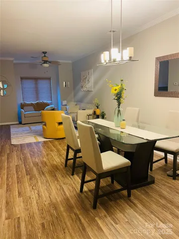 a dining room with a wooden table and chairs