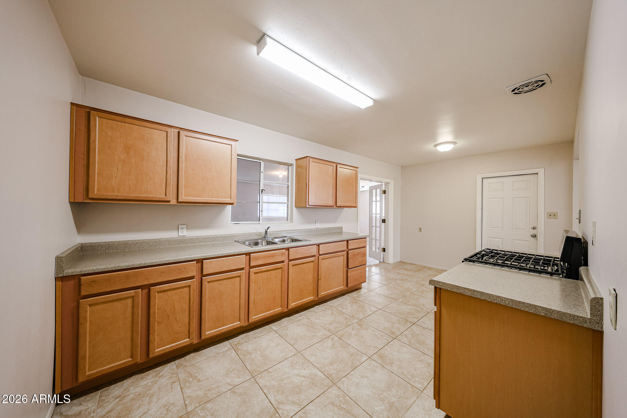 12819 North 22nd Place Phoenix, AZ 85022 - Photo 2 of 28 a kitchen with a sink and cabinets
