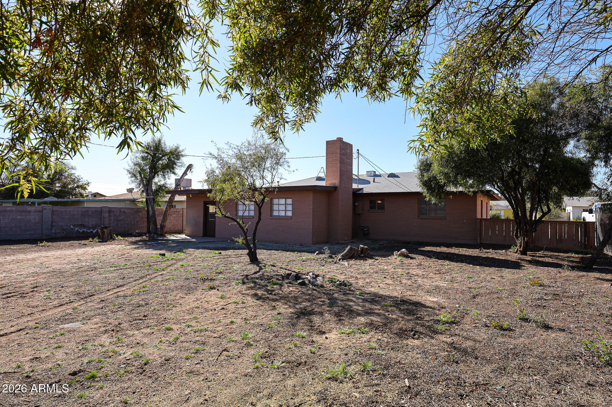 12819 North 22nd Place Phoenix, AZ 85022 - Photo 9 of 28 a wooden house with trees in front of it