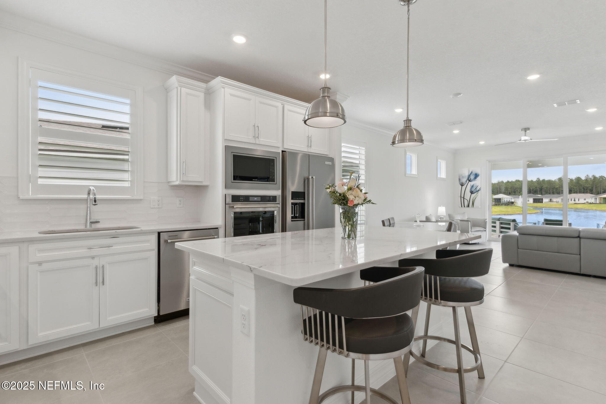 350 Tranquil Trl Circle Yulee, FL 32097 - Photo 5 of 33 a kitchen with stainless steel appliances kitchen island granite countertop a sink and cabinets