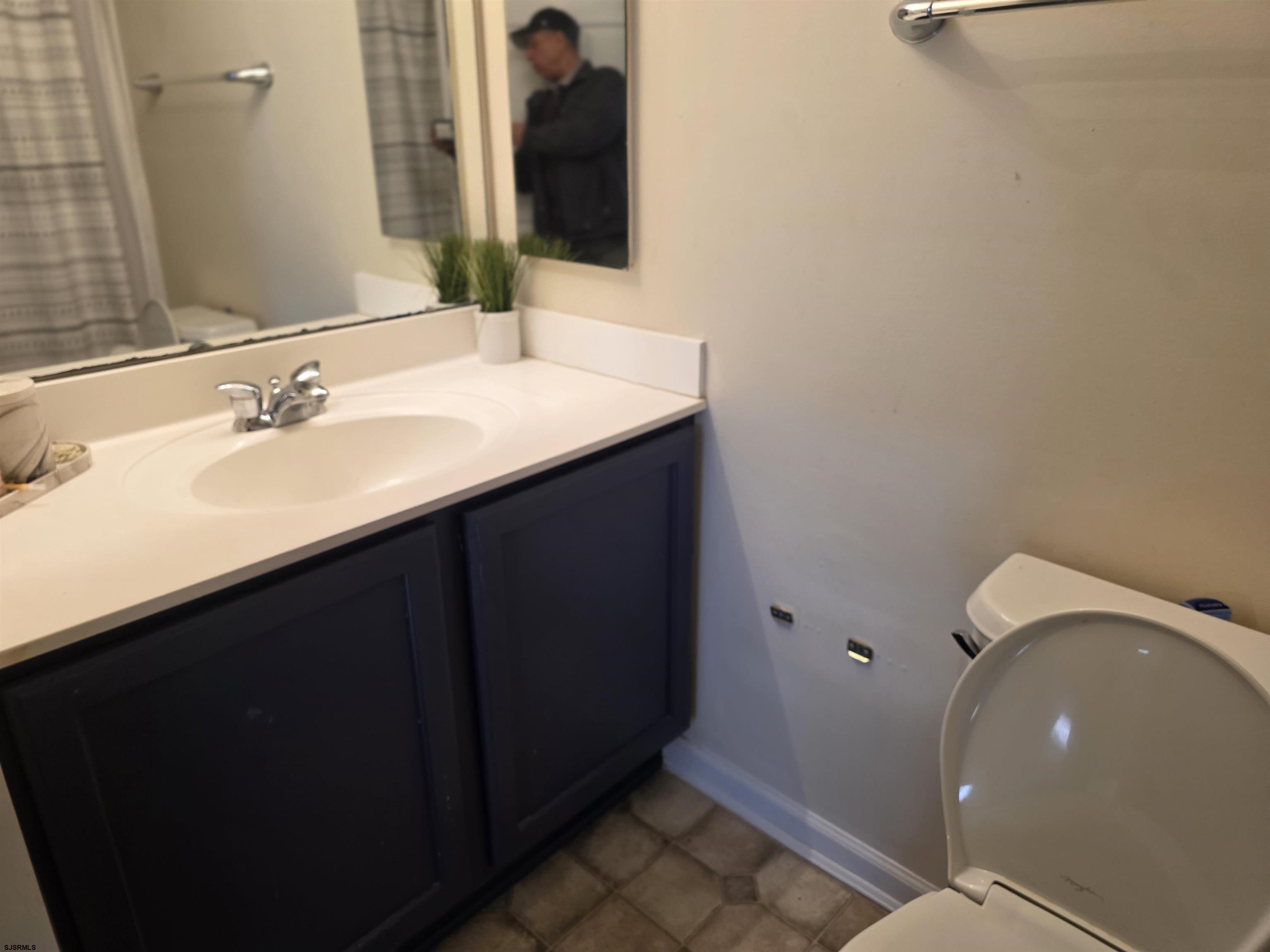 1002 Carlisle Road Egg Harbor Township, NJ 08234 - Photo 15 of 18 a bathroom with a sink and a mirror