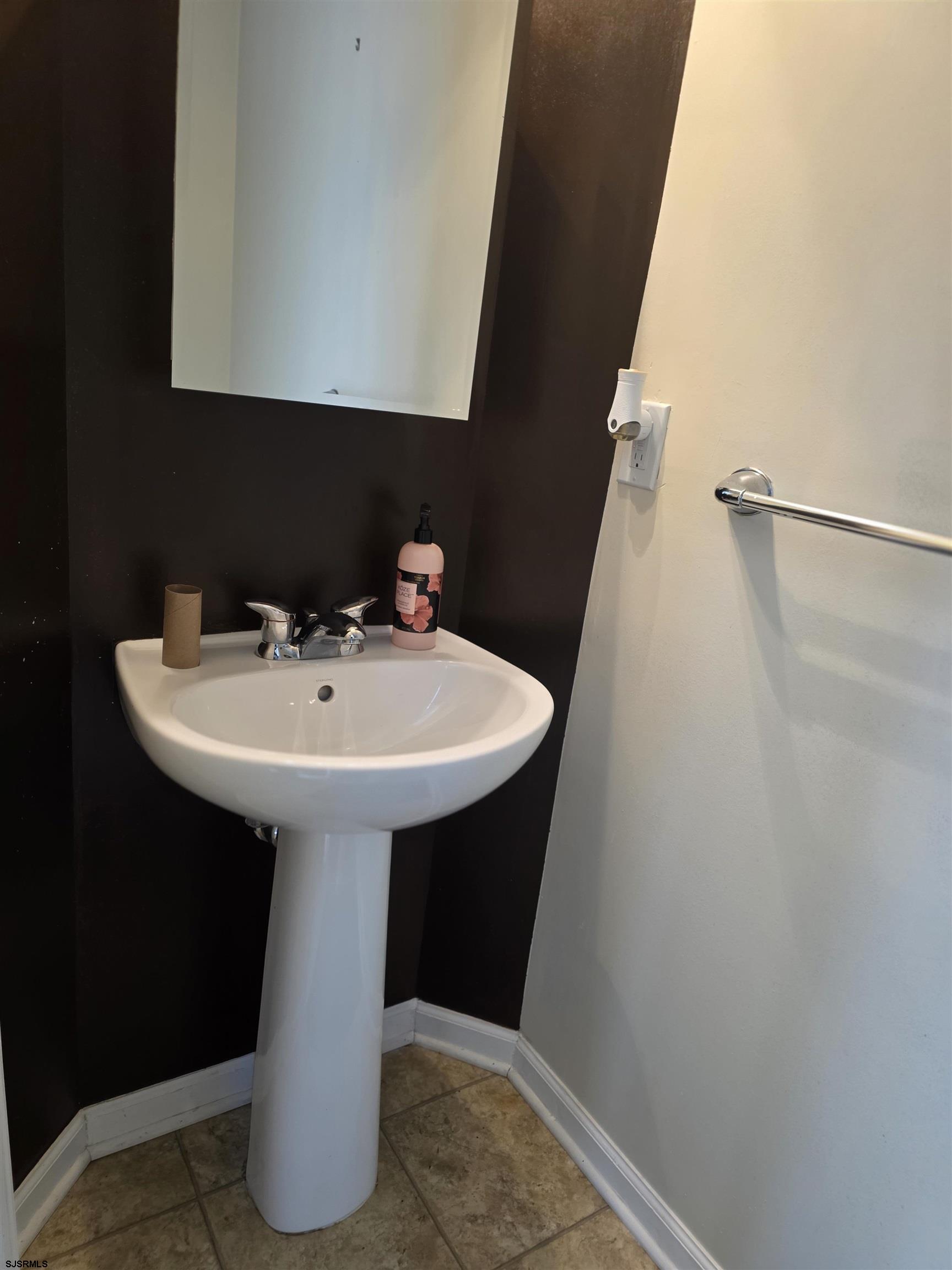 1002 Carlisle Road Egg Harbor Township, NJ 08234 - Photo 17 of 18 a bathroom with a sink and a mirror