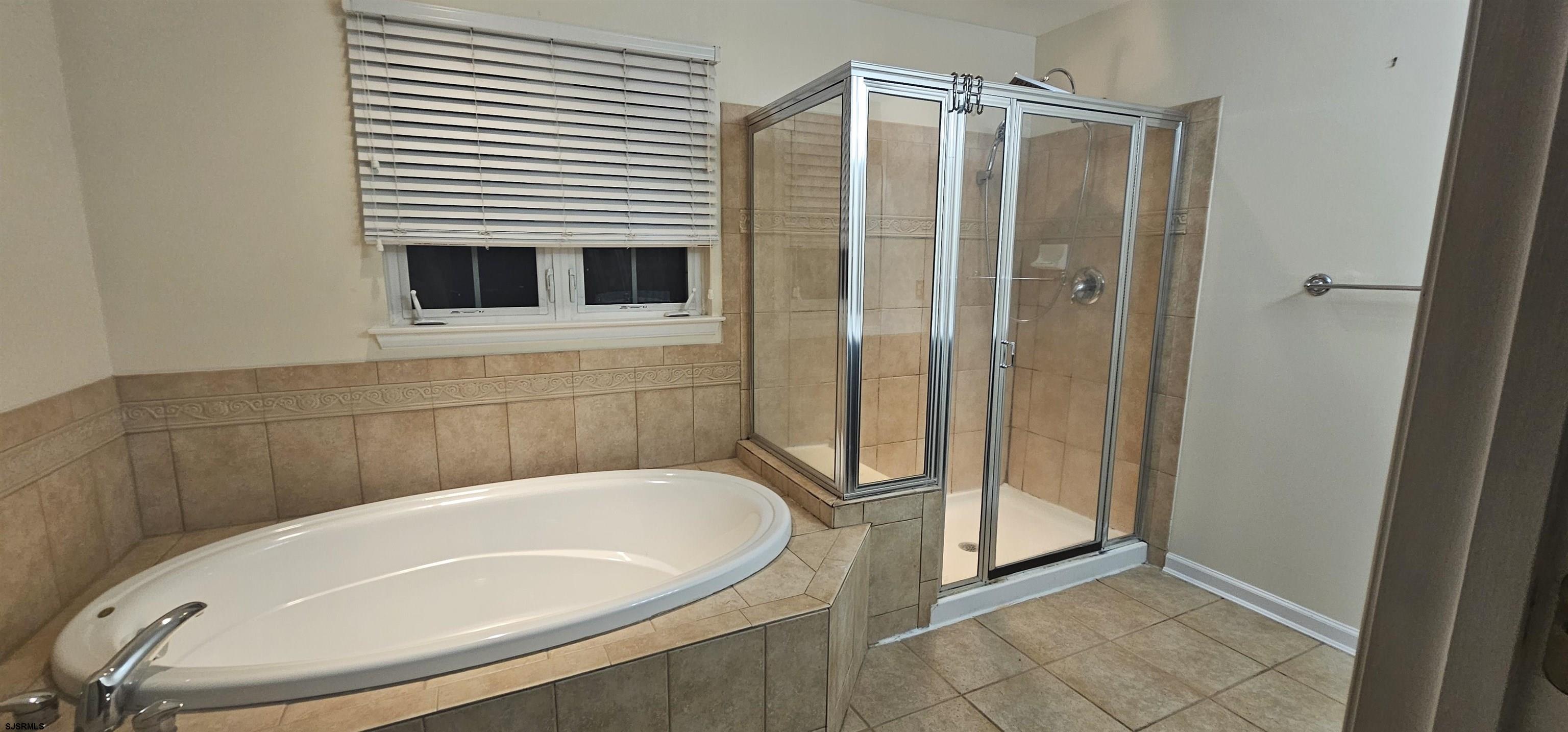 1002 Carlisle Road Egg Harbor Township, NJ 08234 - Photo 2 of 18 a bathroom with a tub and shower