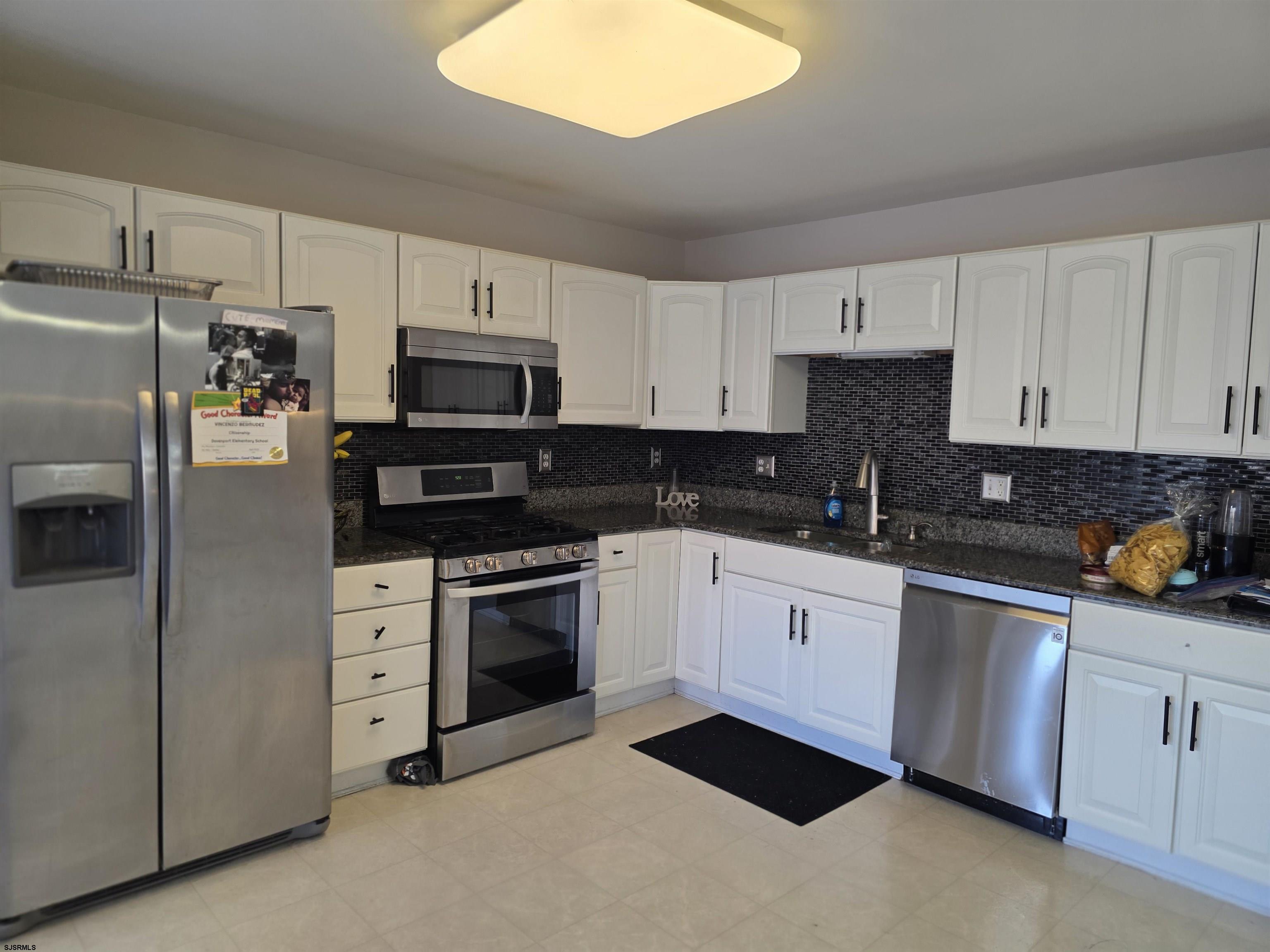 1002 Carlisle Road Egg Harbor Township, NJ 08234 - Photo 5 of 18 a kitchen with granite countertop white cabinets and stainless steel appliances