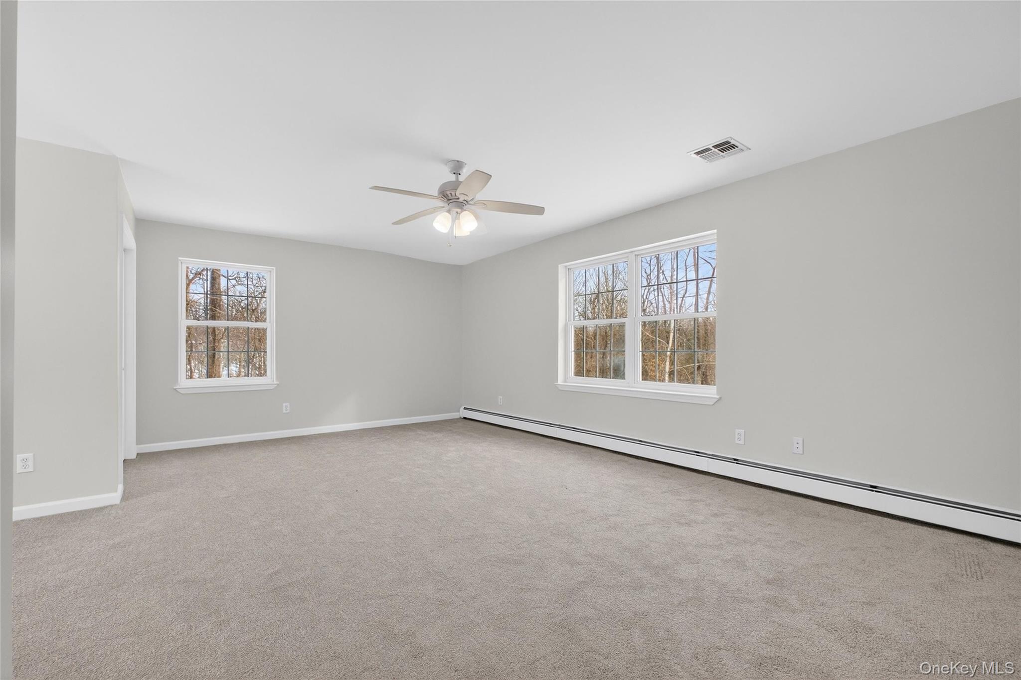 33 Berea Road Walden, NY 12586 - Photo 32 of 44 Empty room with baseboard heating, light colored carpet, and ceiling fan