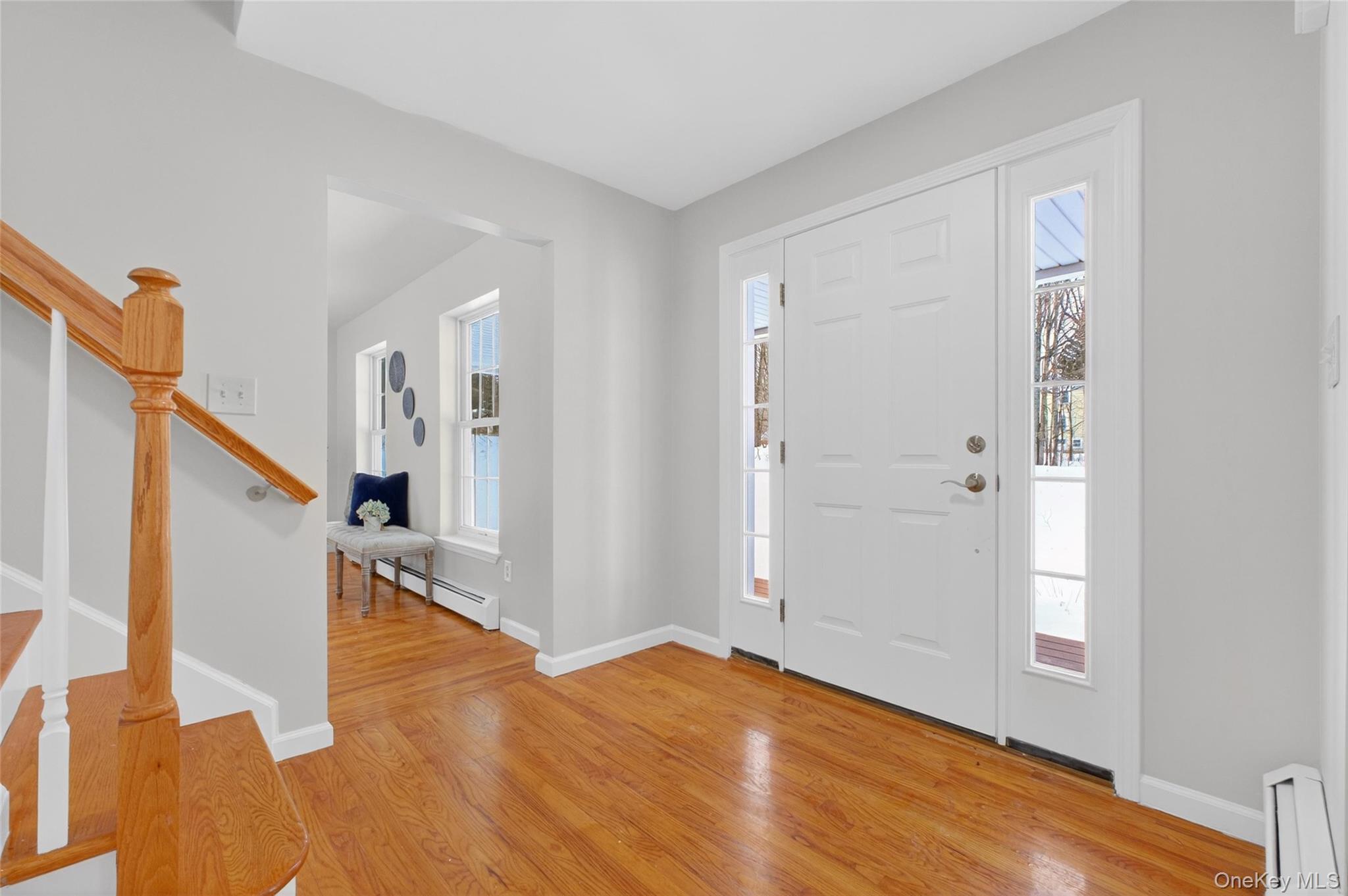 33 Berea Road Walden, NY 12586 - Photo 4 of 44 Entryway featuring light wood-style floors, plenty of natural light, a baseboard radiator, and stairs