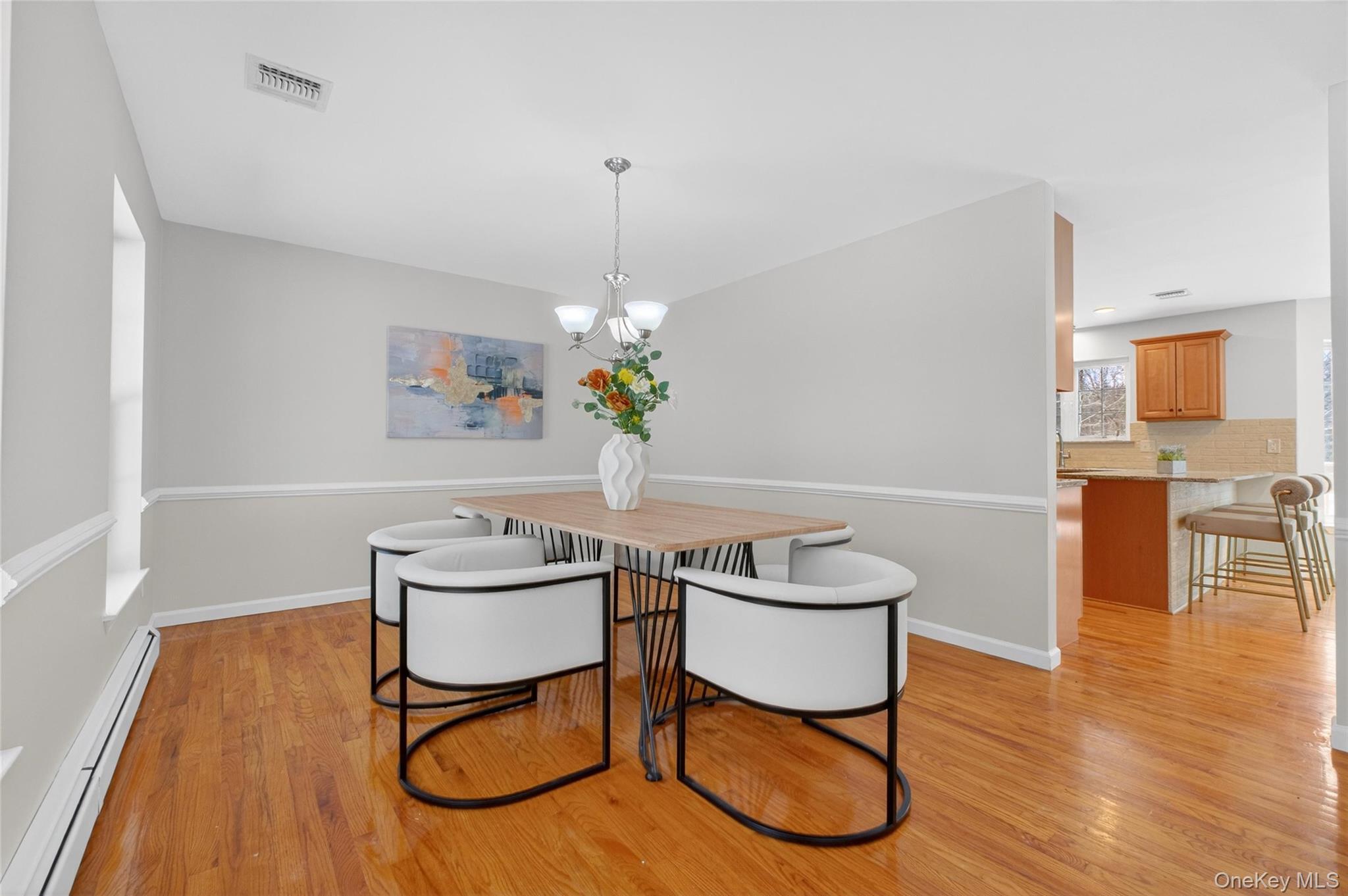 33 Berea Road Walden, NY 12586 - Photo 6 of 44 Dining area with baseboard heating, light wood finished floors, and a chandelier