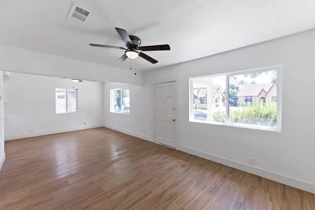 a view of a livingroom with a hardwood floor and a ceiling fan