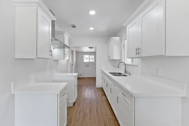 a kitchen with sink refrigerator and stove