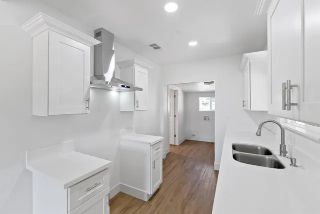 a kitchen with sink and cabinets