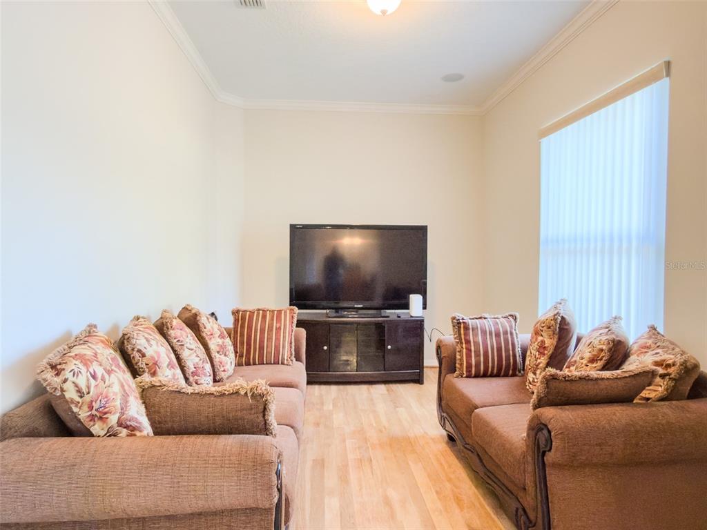 4 Weston Road Leesburg, FL 34748 - Photo 11 of 55 a living room with furniture and a flat screen tv