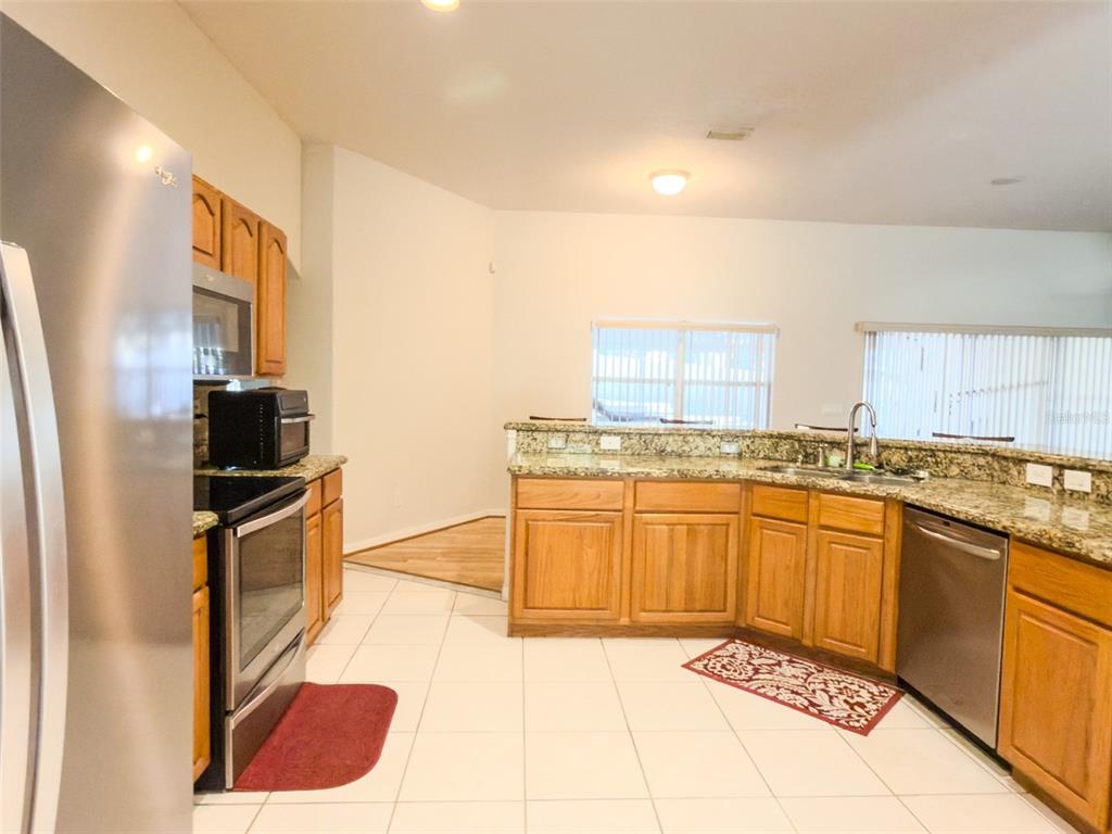 4 Weston Road Leesburg, FL 34748 - Photo 12 of 55 a kitchen with stainless steel appliances granite countertop a sink and cabinets