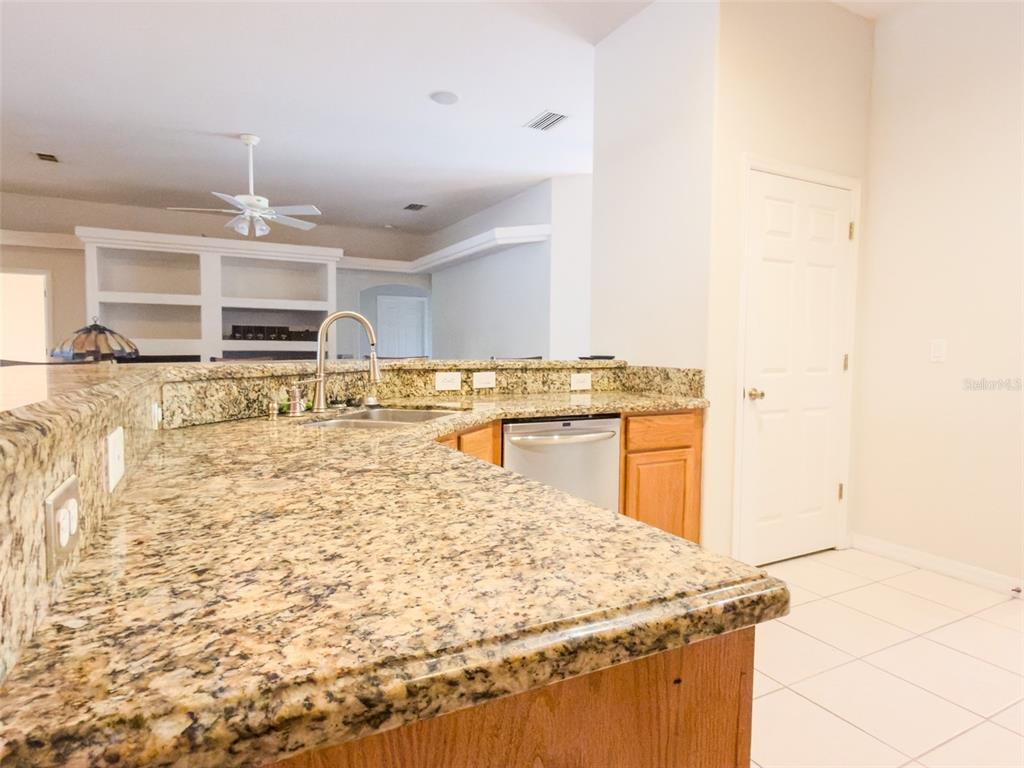 4 Weston Road Leesburg, FL 34748 - Photo 15 of 55 a kitchen with stainless steel appliances granite countertop a sink stove and cabinets