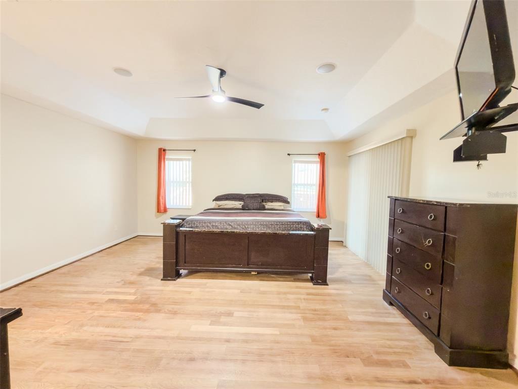 4 Weston Road Leesburg, FL 34748 - Photo 17 of 55 a spacious bedroom with a bed and a mirror