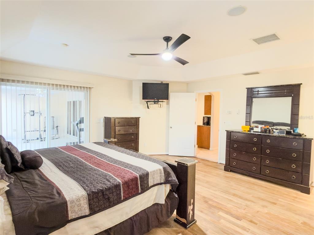 4 Weston Road Leesburg, FL 34748 - Photo 19 of 55 a bedroom with a bed and a dresser