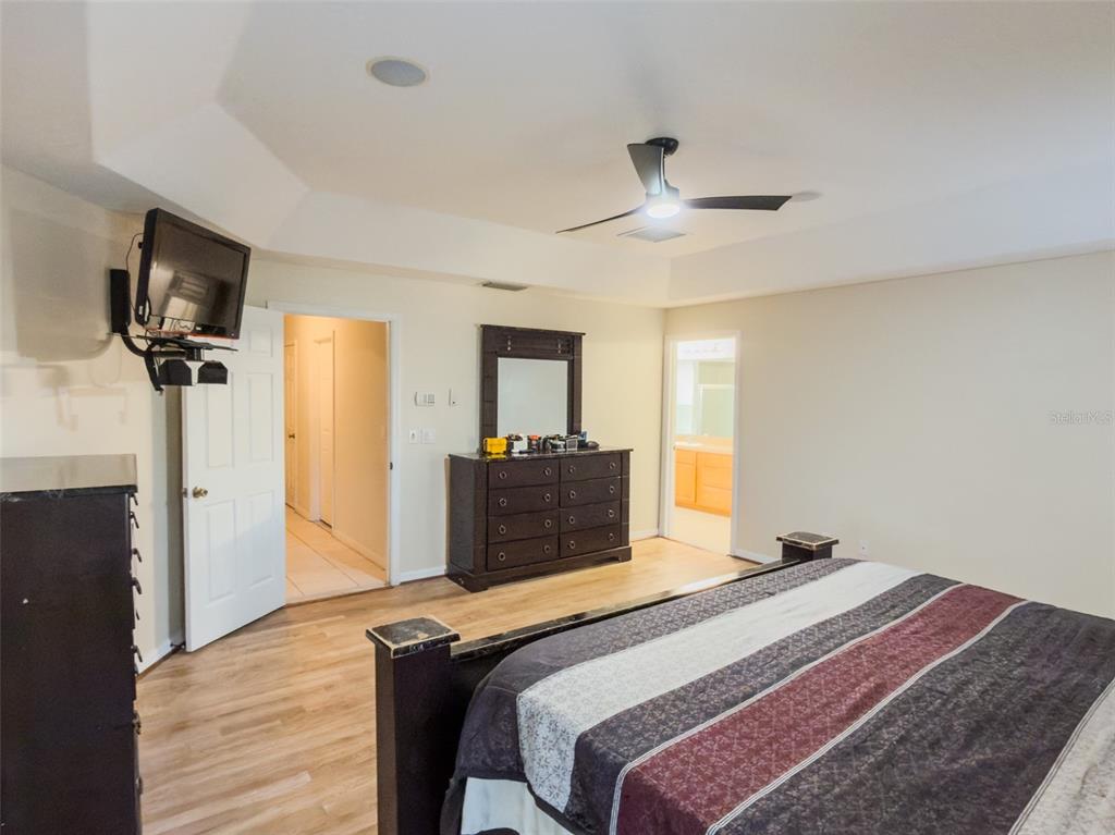 4 Weston Road Leesburg, FL 34748 - Photo 20 of 55 a bedroom with a bed and a flat screen tv