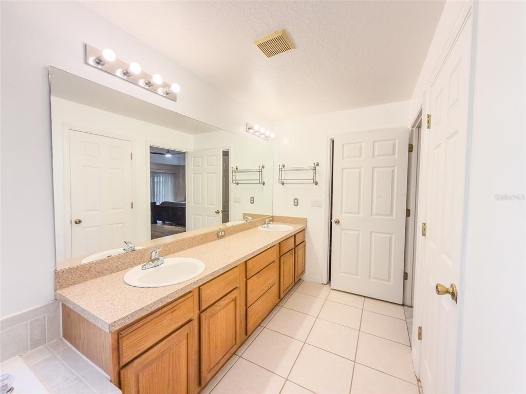 4 Weston Road Leesburg, FL 34748 - Photo 21 of 55 a bathroom with a sink mirror and a shower