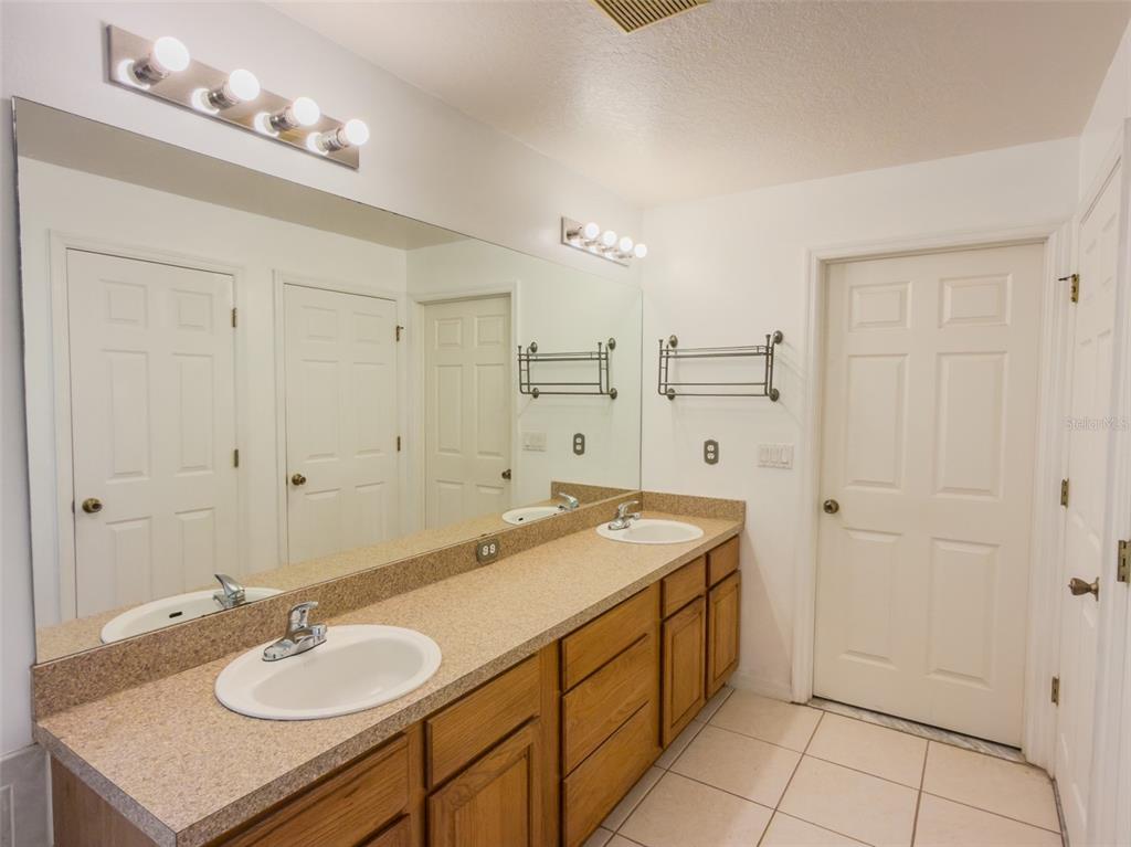 4 Weston Road Leesburg, FL 34748 - Photo 22 of 55 a spacious bathroom with a granite countertop sink a mirror and a