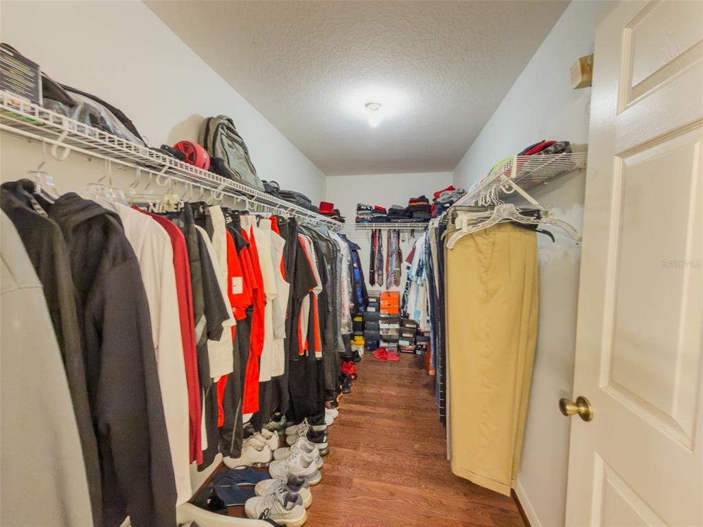 4 Weston Road Leesburg, FL 34748 - Photo 27 of 55 a view of walk in closet with clothes and shoes