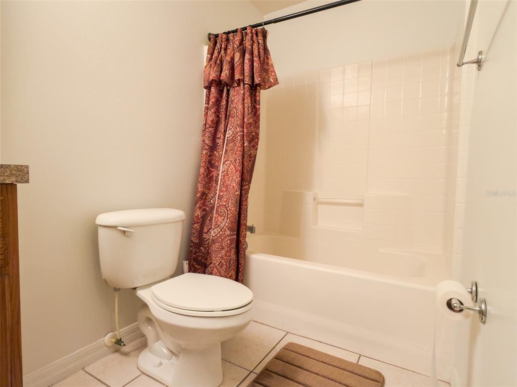 4 Weston Road Leesburg, FL 34748 - Photo 29 of 55 a white toilet sitting next to a bath tub shower