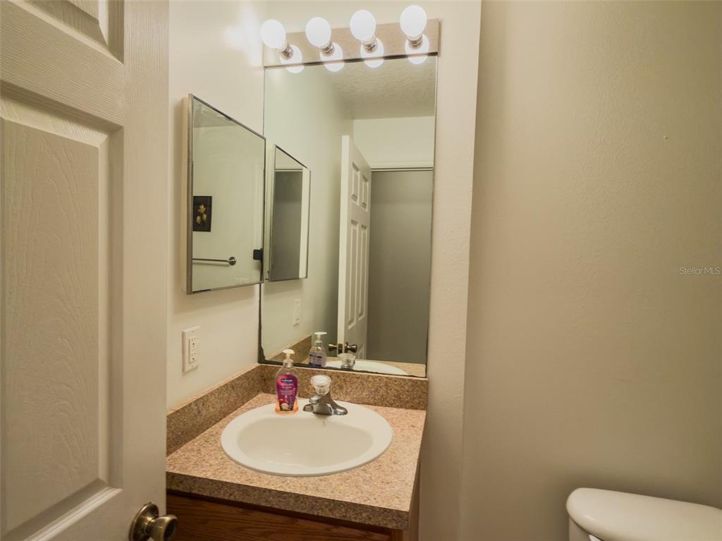 4 Weston Road Leesburg, FL 34748 - Photo 30 of 55 a bathroom with a sink and a mirror