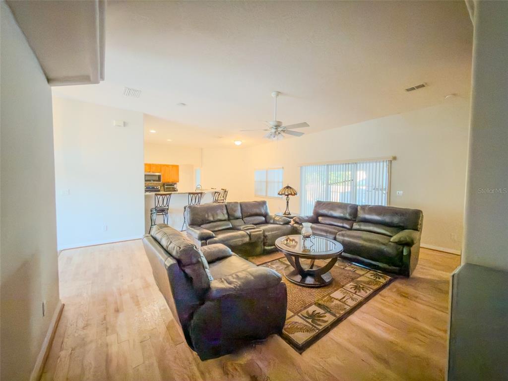 4 Weston Road Leesburg, FL 34748 - Photo 32 of 55 a living room with furniture and a large window