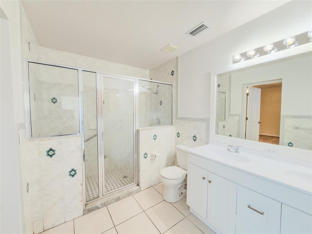 4 Weston Road Leesburg, FL 34748 - Photo 38 of 55 a spacious bathroom with a granite countertop sink a toilet and shower