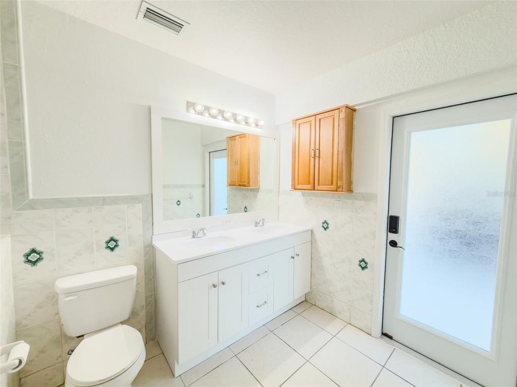 4 Weston Road Leesburg, FL 34748 - Photo 39 of 55 a spacious bathroom with a granite countertop toilet a sink and a mirror