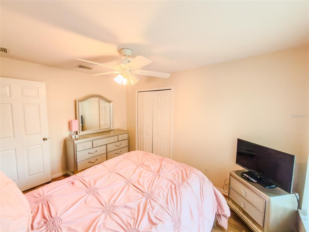 4 Weston Road Leesburg, FL 34748 - Photo 42 of 55 a bedroom with a bed and a television