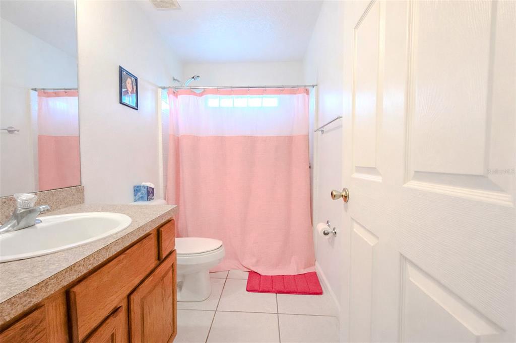 4 Weston Road Leesburg, FL 34748 - Photo 43 of 55 a bathroom with a sink a toilet and shower curtain