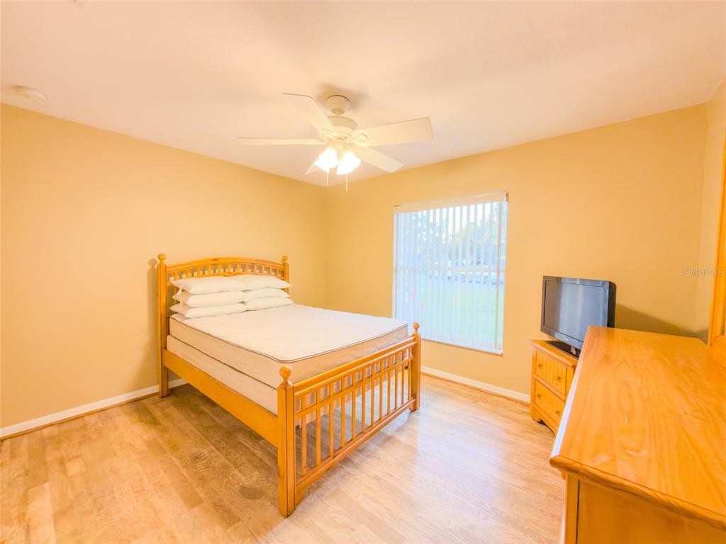 4 Weston Road Leesburg, FL 34748 - Photo 45 of 55 a bedroom with a bed and a night stand