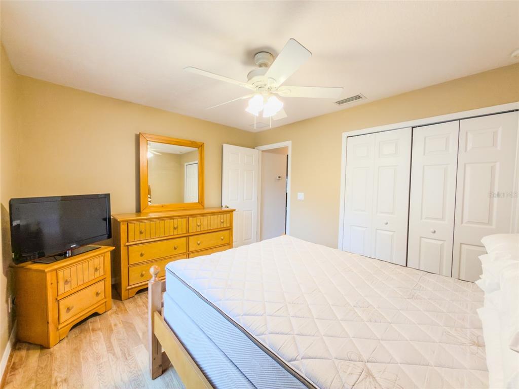 4 Weston Road Leesburg, FL 34748 - Photo 46 of 55 a bedroom with a bed and a flat screen tv