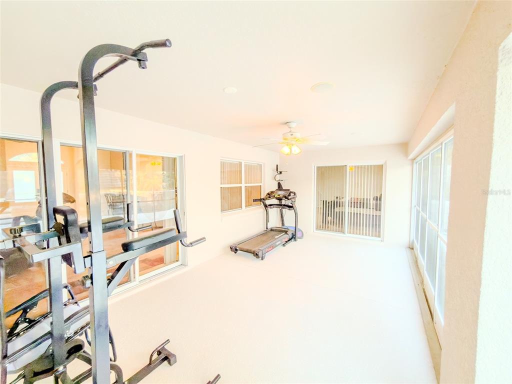 4 Weston Road Leesburg, FL 34748 - Photo 50 of 55 a view of a living room with furniture and floor to ceiling window