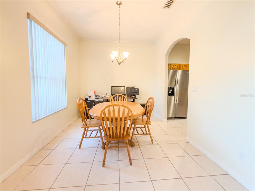 4 Weston Road Leesburg, FL 34748 - Photo 9 of 55 a dining room with furniture and a chandelier