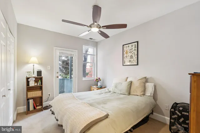 a spacious bedroom with a bed and a window