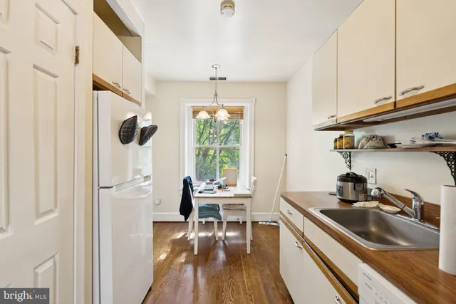 a kitchen with stainless steel appliances a sink a stove and a refrigerator