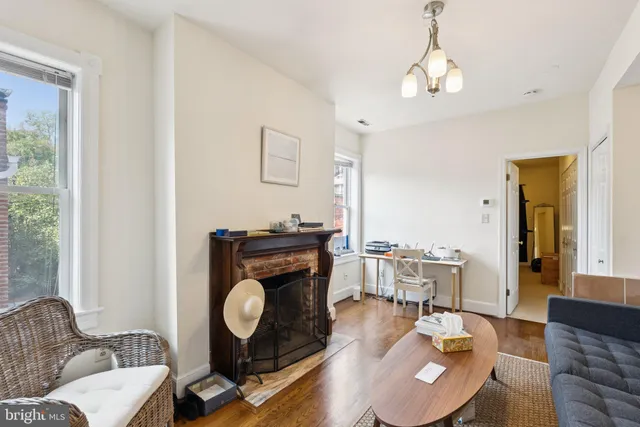 a living room with furniture a dining table and a window