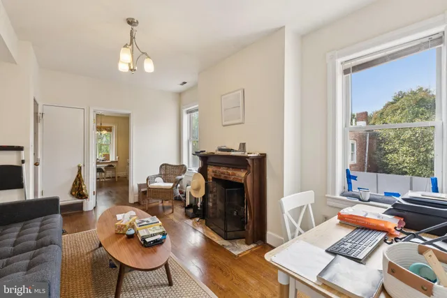 a living room with furniture a rug and a window