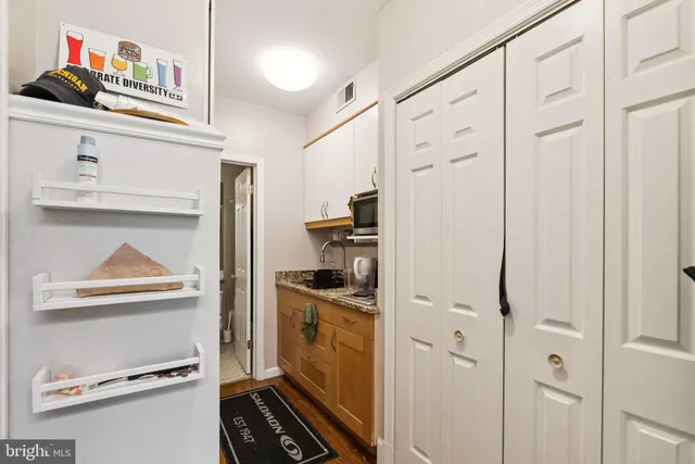 a kitchen with stainless steel appliances granite countertop a refrigerator and a stove