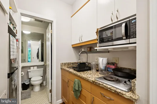 a kitchen with stainless steel appliances granite countertop a stove and a microwave